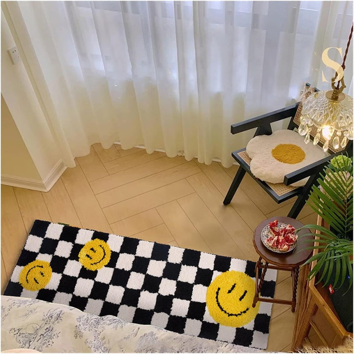The VibeCore Retro Remix Accent Rug featuring a smiley design, placed by the bed. This playful, retro-inspired rug adds a cheerful touch to the room, enhancing the space with its soft texture and vibrant design.