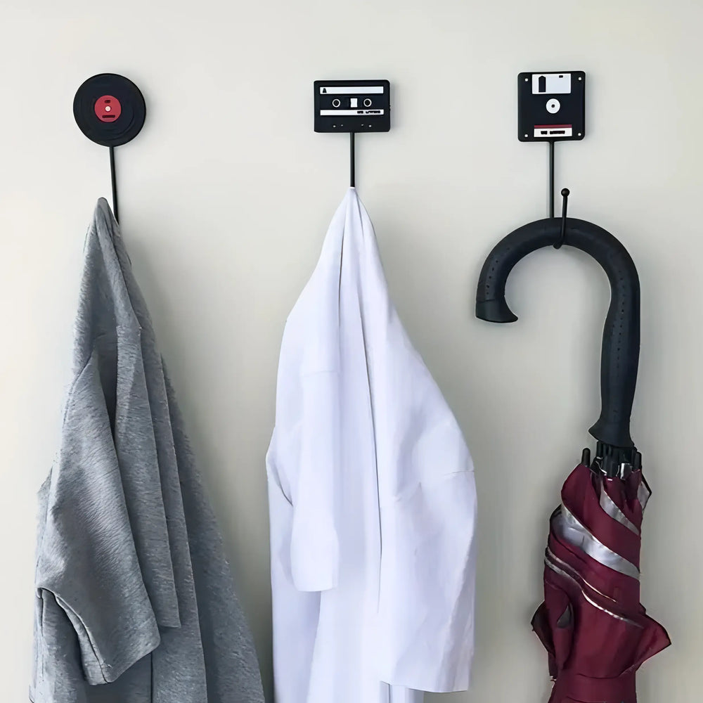 VibeCore Retro Wall Hook set featuring floppy disk, vinyl record, and cassette tape hooks, each holding a shirt and an umbrella, showcasing their stylish and functional design.