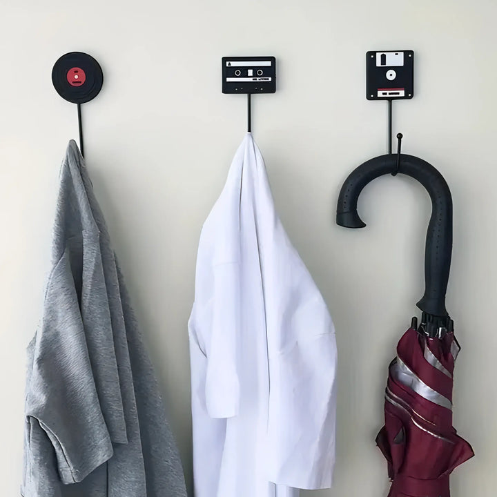 VibeCore Retro Wall Hook set featuring floppy disk, vinyl record, and cassette tape hooks, each holding a shirt and an umbrella, showcasing their stylish and functional design.