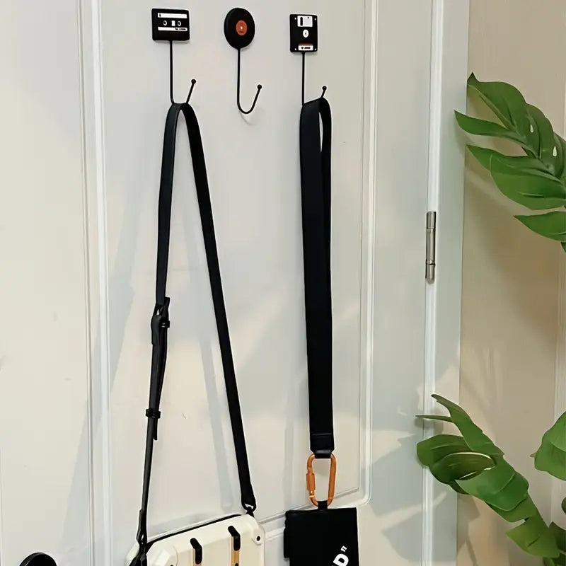 VibeCore Retro Wall Hook set featuring a floppy disk, vinyl record, and cassette tape mounted on the back of a door, each providing a stylish and functional way to hang items.