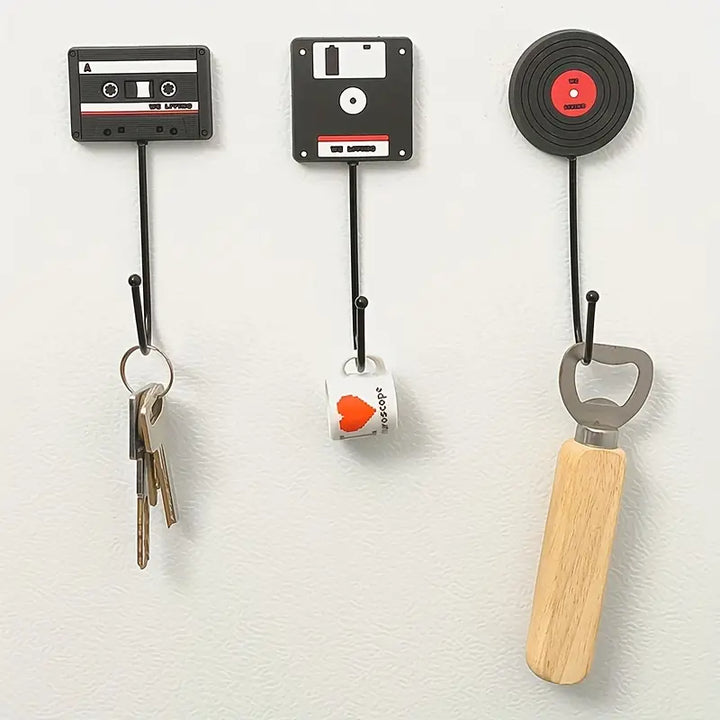 VibeCore Retro Wall Hook set featuring a floppy disk, vinyl record, and cassette tape installed on a wall, each serving as unique and functional hooks for hanging various items.