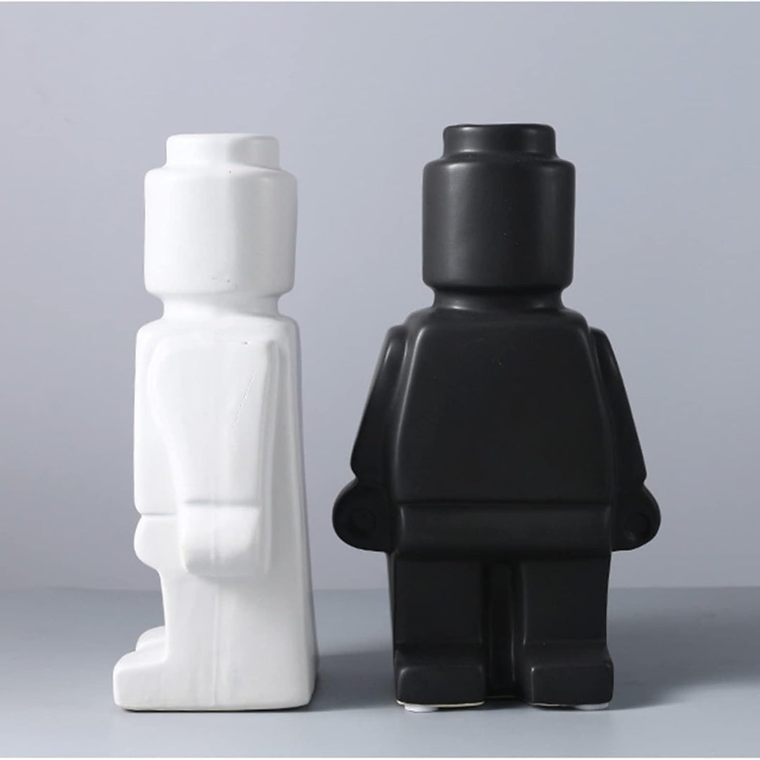 Aesthetic close-up of the black and white robot vases showcasing their sleek minimalist designs and pop-culture influence perfect for adding bold artistic touches to modern home decor.