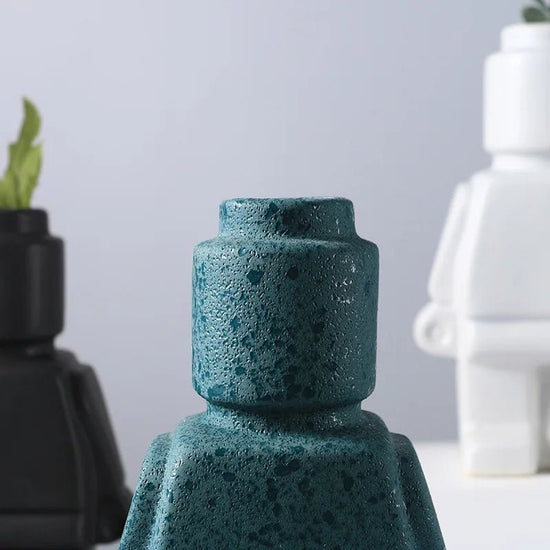 Aesthetic close-up of the turquoise robot vase head showcasing its sleek minimalist design and pop-culture influence perfect for adding a bold artistic touch to modern home decor.