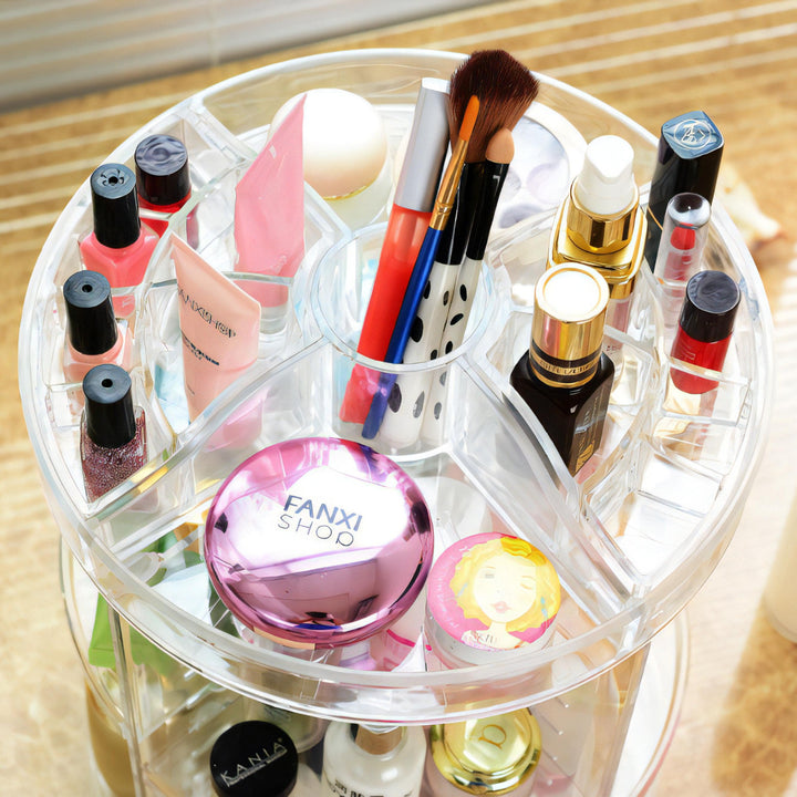 VibeCore Rotating Clear Makeup Organizer aerial view showcasing the top. Clear acrylic design with 360-degree rotation, visible compartments for brushes, cosmetics, and skincare. Ideal for modern vanity or countertop organization with adjustable tiers for versatile storage.