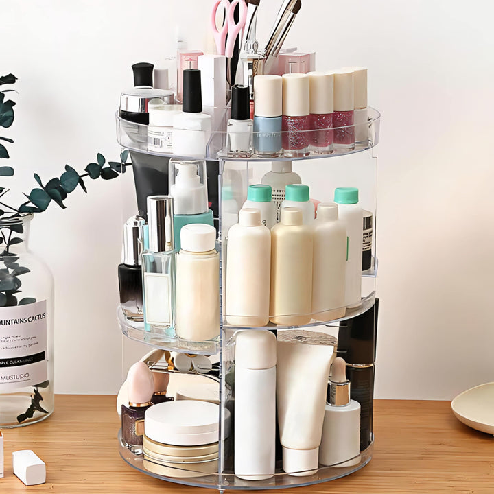 VibeCore Rotating Clear Makeup Organizer on a vanity from a different angle. Elegant, transparent acrylic with adjustable tiers and smooth 360-degree rotation for easy access.