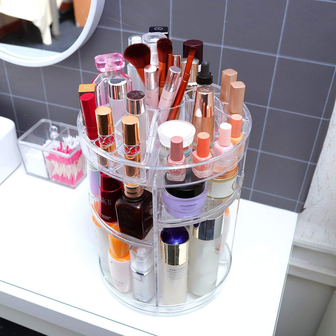 VibeCore Rotating Clear Makeup Organizer angled aerial view. Sleek acrylic design with 360-degree rotation, adjustable tiers, and spacious compartments for cosmetics, skincare, and brushes. Perfect for vanity or bathroom organization.