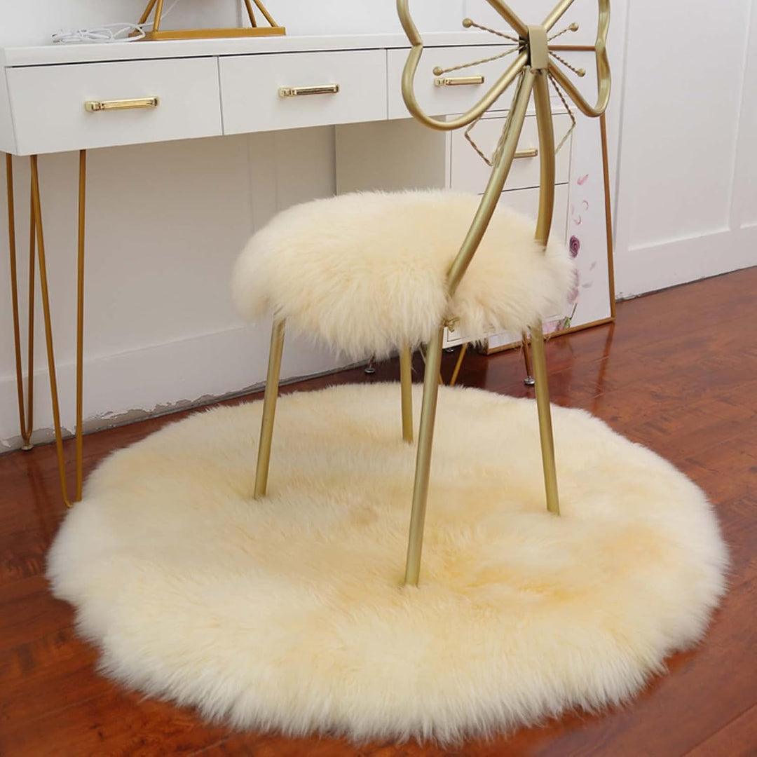 VibeCore Round Faux Fur Accent Rug in beige on the floor, also used as a seat cover. Soft, fluffy texture with a non-slip backing, perfect for bedrooms, living rooms, or dorm rooms. Easy to clean, available in multiple colors.