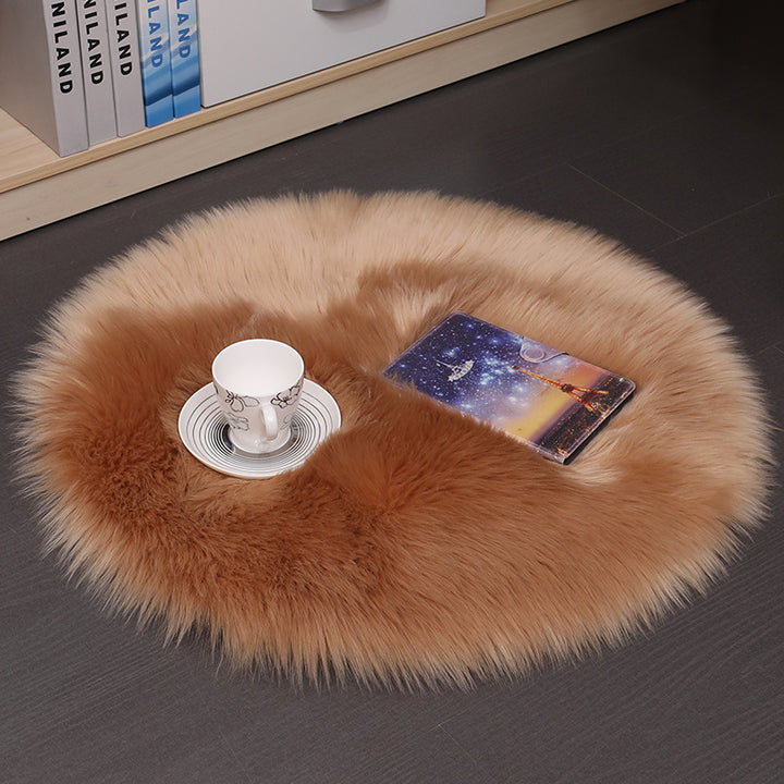 VibeCore Round Faux Fur Accent Rug in khaki on the floor. Soft, fluffy texture with a non-slip backing, ideal for adding comfort to bedrooms, living rooms, or dorm rooms. Easy to clean, available in multiple colors.