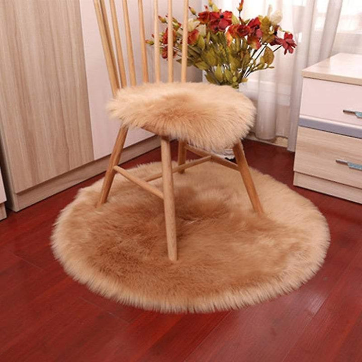 VibeCore Round Faux Fur Accent Rug in khaki on the floor, also used as a seat cover. Soft, fluffy texture with a non-slip backing, perfect for bedrooms, living rooms, or dorm rooms. Easy to clean, available in multiple colors.