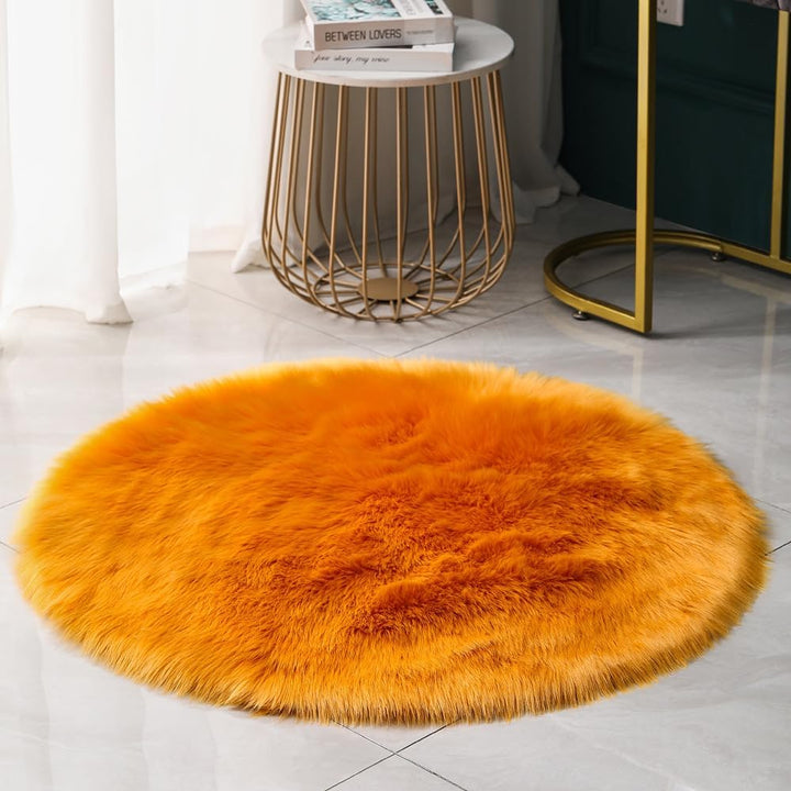 VibeCore Round Faux Fur Accent Rug in orange on the floor. Soft, fluffy texture with a non-slip backing, perfect for bedrooms, living rooms, or dorm rooms. Easy to clean, available in multiple colors.