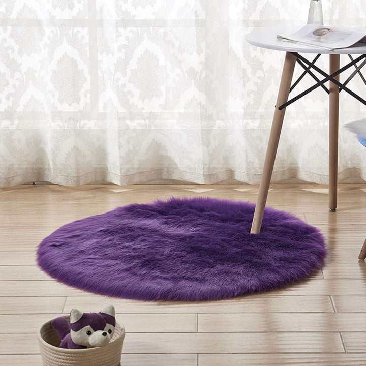 VibeCore Round Faux Fur Accent Rug in purple on the floor. Soft, fluffy texture with a non-slip backing, perfect for bedrooms, living rooms, or dorm rooms. Easy to clean, available in multiple colors.