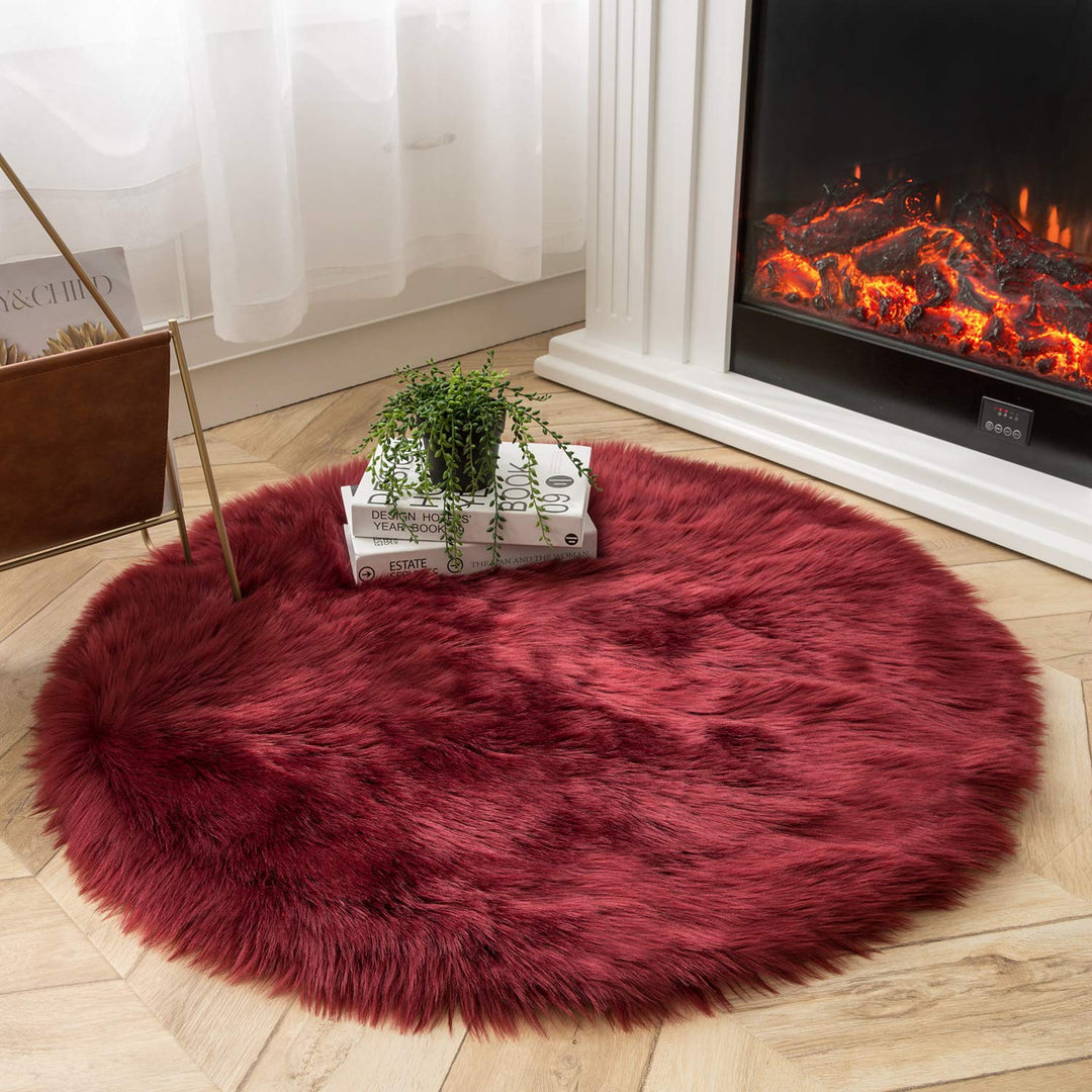 VibeCore Round Faux Fur Accent Rug in red on the floor. Soft, fluffy texture with a non-slip backing, perfect for bedrooms, living rooms, or dorm rooms. Easy to clean, available in multiple colors.