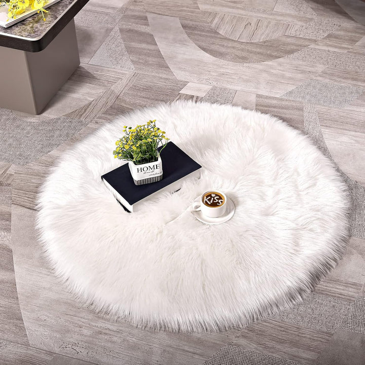 The VibeCore Round Faux Fur Accent Rug in White placed on the floor, displaying its soft, plush texture and sleek round shape, perfect for enhancing the comfort and style of any room.