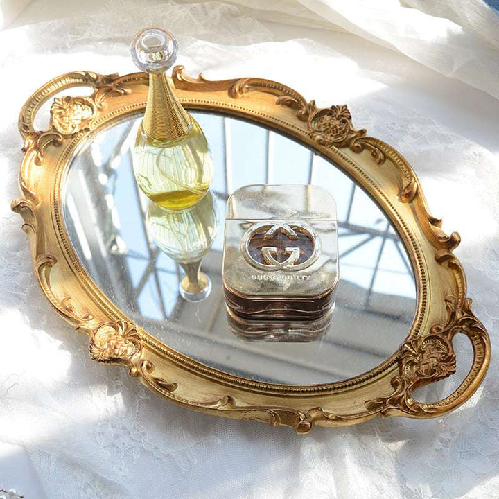 VibeCore Round Royal Mirror Tray in Gold, with perfume, highlighting its elegant resin-crafted design. Perfect for organizing perfumes, jewelry, or decor, adding a touch of European charm and refinement to any surface.