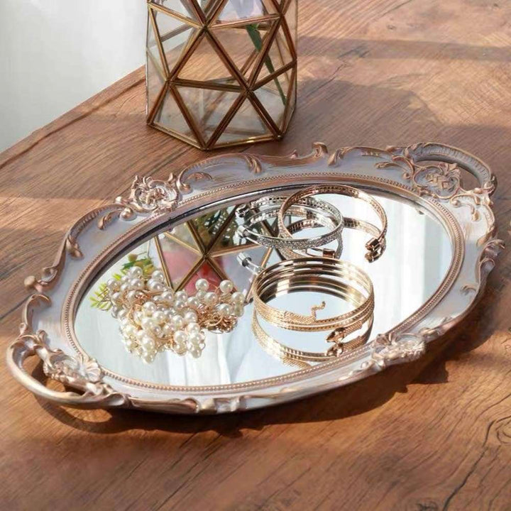 VibeCore Round Royal Mirror Tray in Silver with Gold Edges, featuring jewelry, showcasing its elegant resin-crafted design. A perfect piece for organizing and displaying jewelry, adding a luxurious European touch to any surface.