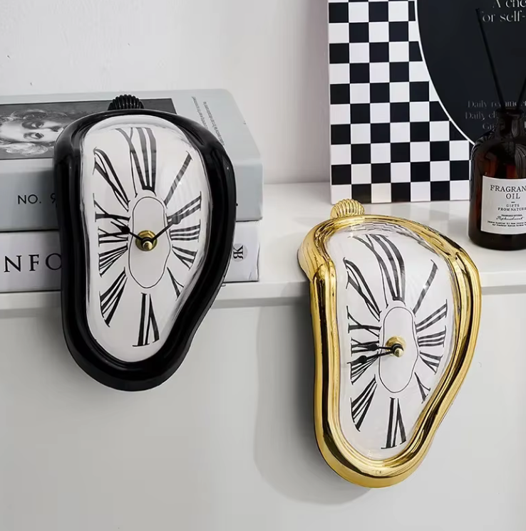 Aesthetic Salvador Dali-inspired melting clock in black and gold with a surreal, draped design, blending functionality and artistic creativity. Perfect for adding a unique statement piece to any space.