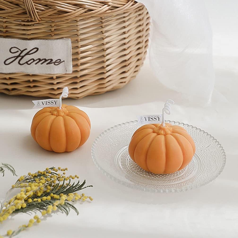 Two orange scented pumpkin candles, featuring cozy pumpkin-shaped designs and warm fragrance, perfect for adding a touch of fall charm and seasonal ambiance to your room decor.