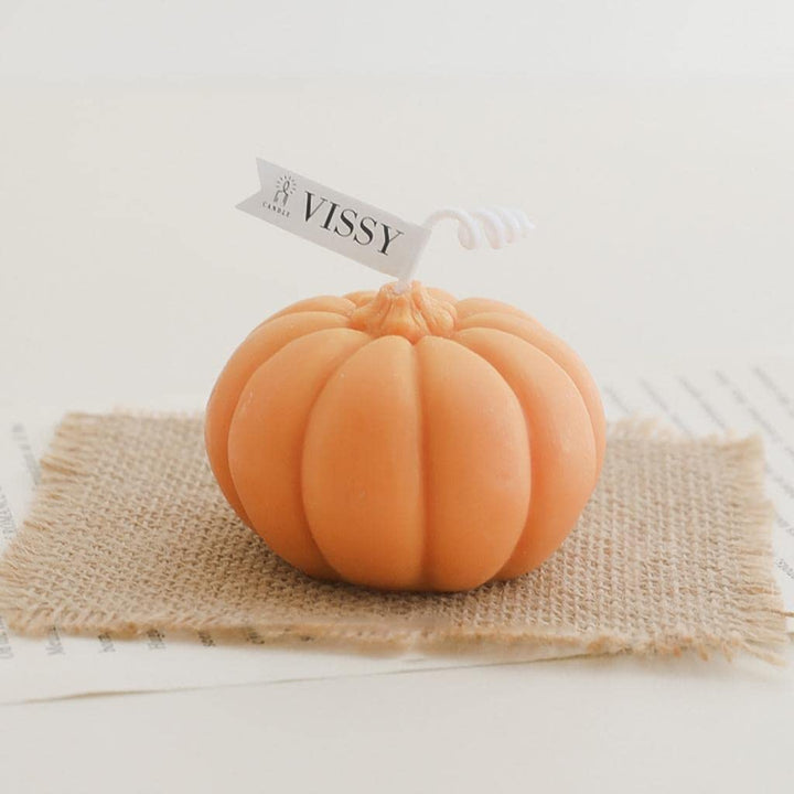 Orange scented pumpkin candle, featuring a cozy pumpkin-shaped design and warm fragrance, perfect for adding a touch of fall charm and seasonal ambiance to your room decor.