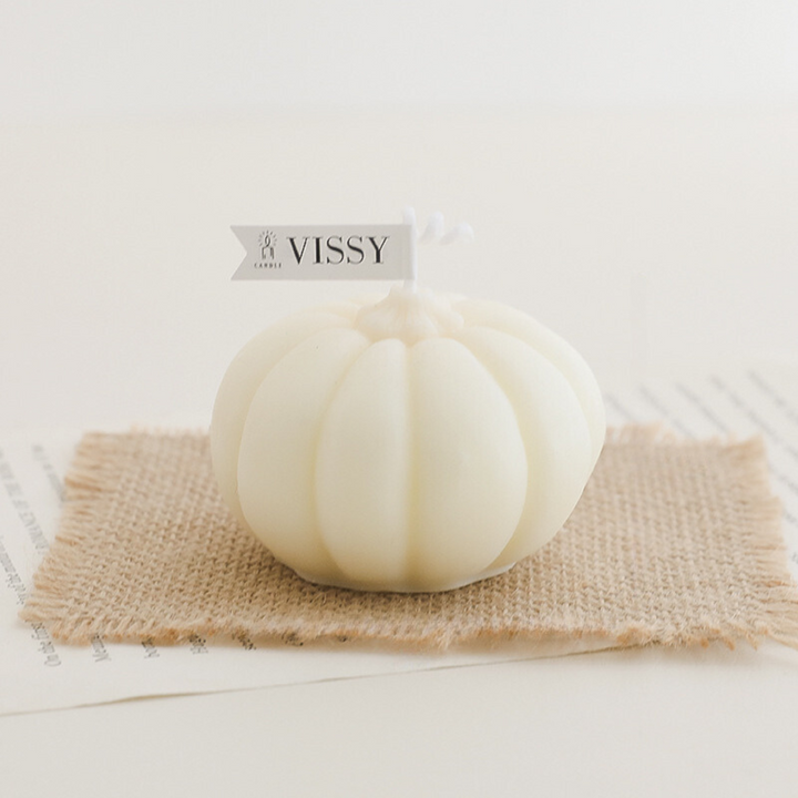 White scented pumpkin candle, featuring a cozy pumpkin-shaped design and warm fragrance, perfect for adding a touch of fall charm and seasonal ambiance to your room decor.