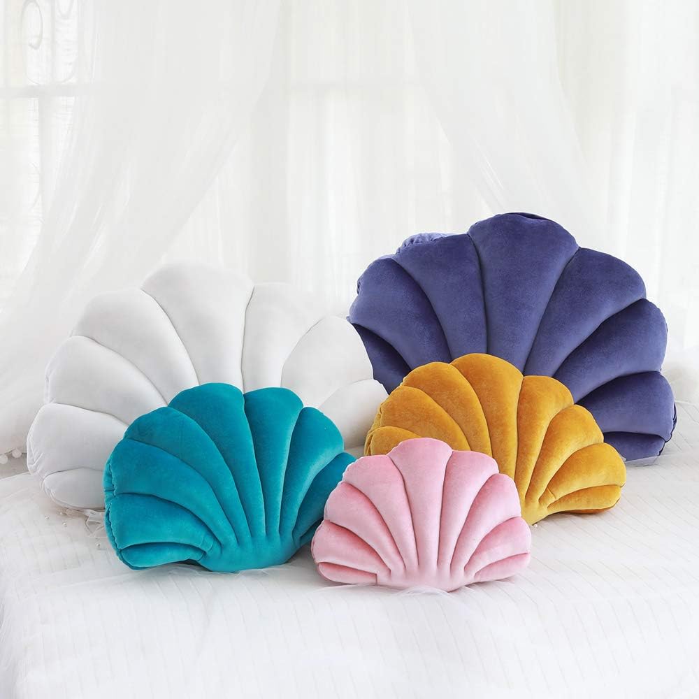 Velvet seashell throw pillow in select colors like blue, pink, and white, available in various sizes. Soft, ocean-inspired cushion for coastal or aesthetic room decor, adding cozy charm to any space.