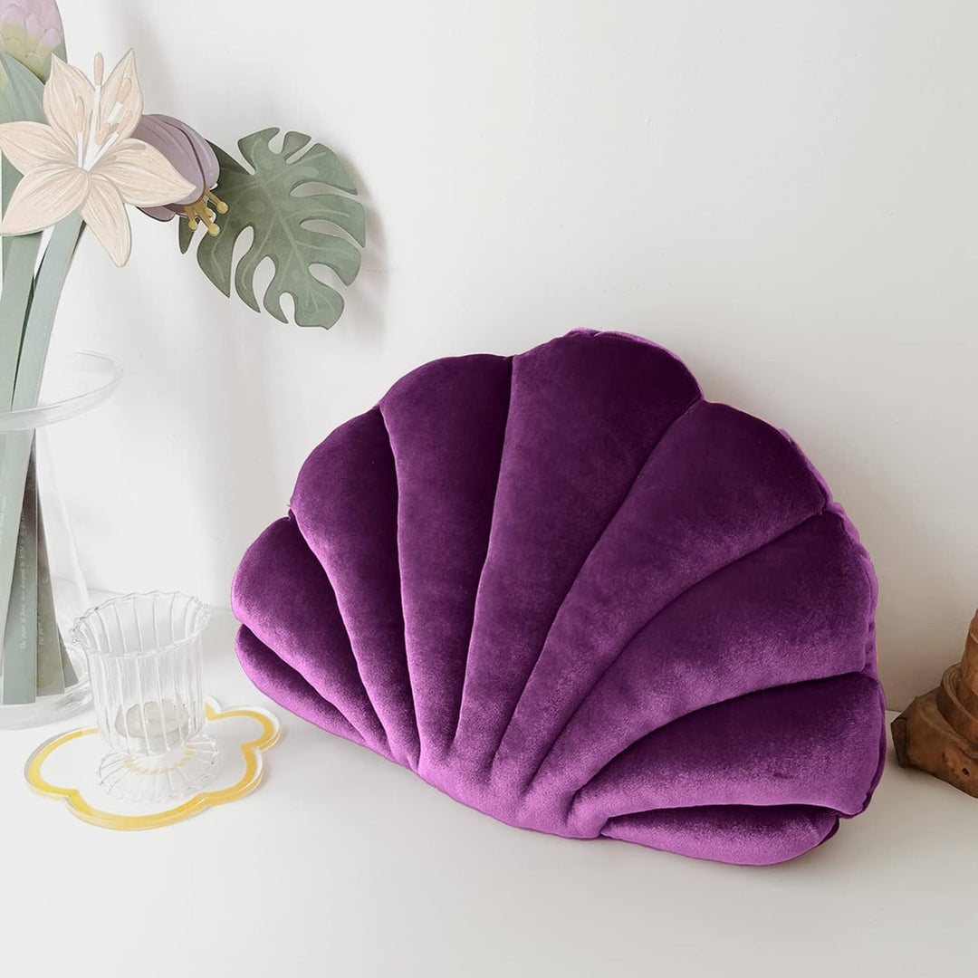Deep purple velvet seashell throw pillow, plush and cozy, adding a rich coastal vibe to any space. Aesthetic accent cushion perfect for vibrant, stylish decor in bedrooms, dorms, or living areas.