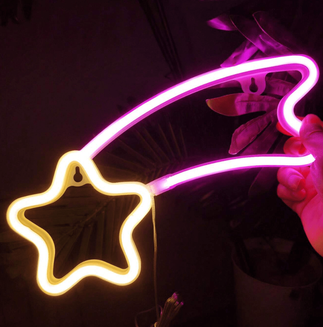VibeCore Shooting Star Neon Light in pink and yellow, glowing brightly to create a dreamy, celestial atmosphere in the space.