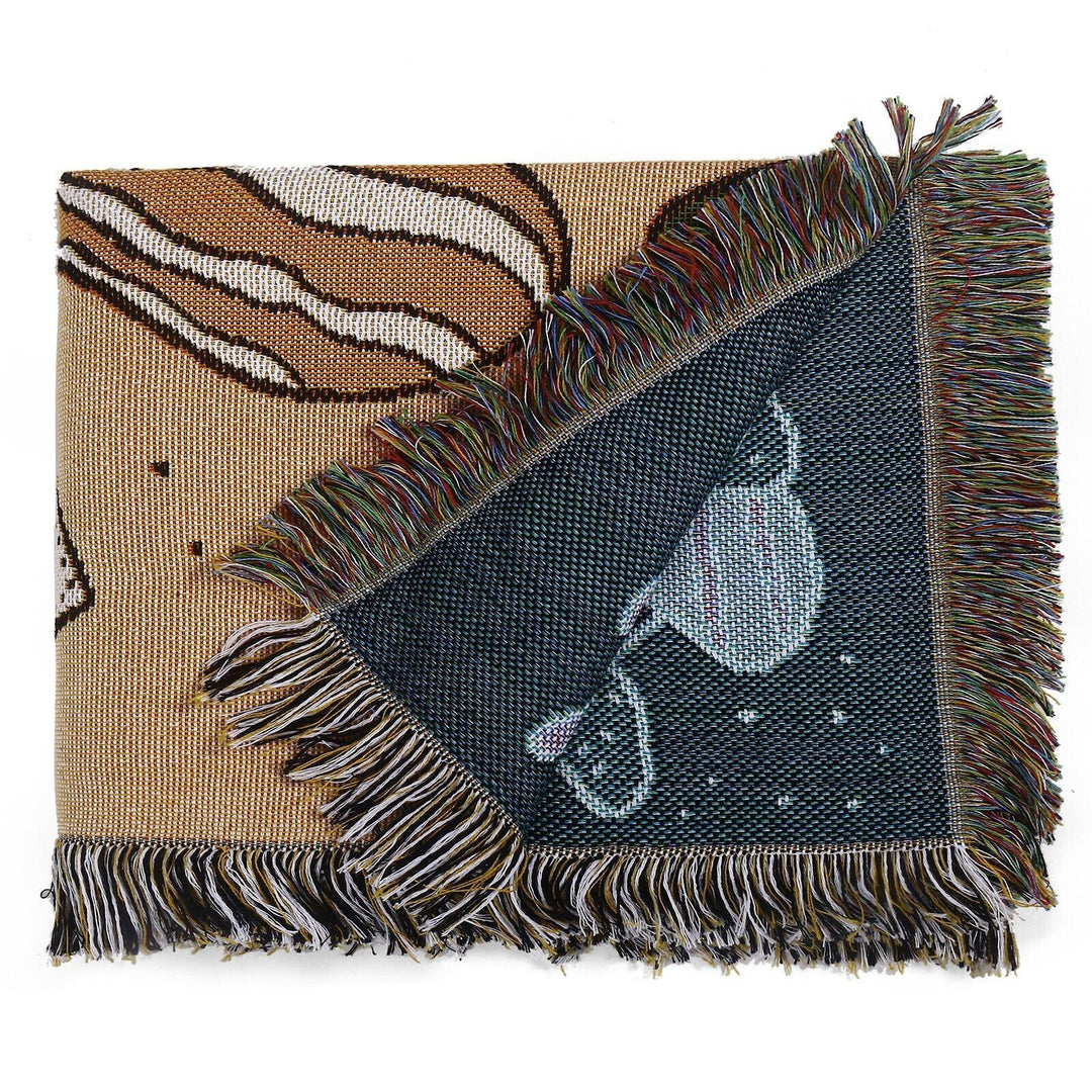VibeCore Shroom Magic Woven Blanket neatly folded, highlighting its dreamy mushroom design and soft, reversible cotton texture.