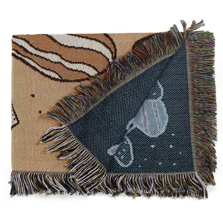 VibeCore Shroom Magic Woven Blanket neatly folded, highlighting its dreamy mushroom design and soft, reversible cotton texture.