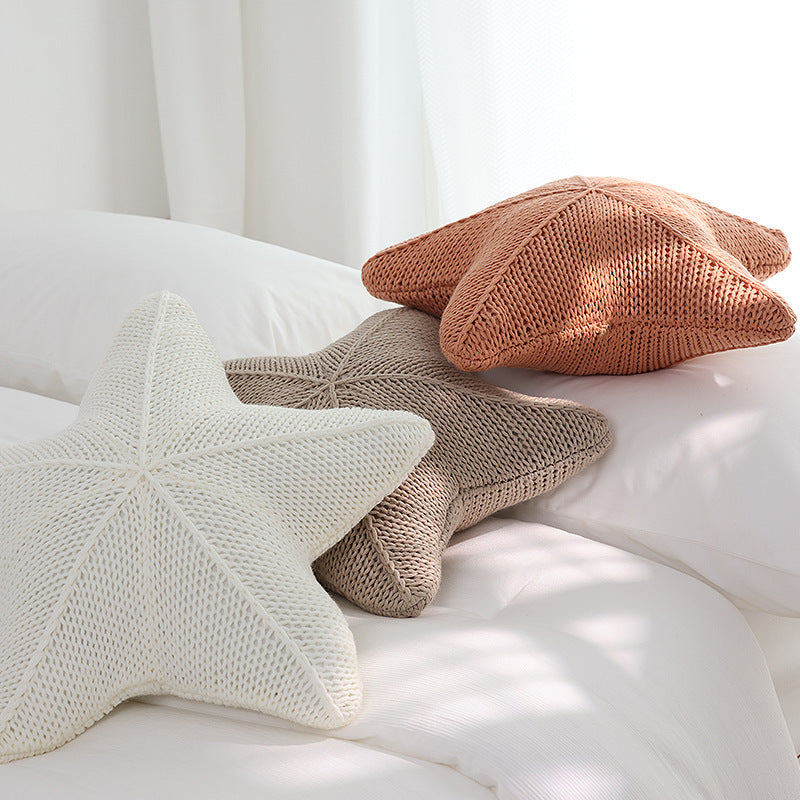 VibeCore Starfish Hand-Knitted Throw Pillow in three colors, side view showcasing the detailed starfish shape and soft, hand-knitted texture for a unique coastal accent.