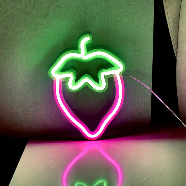 VibeCore Strawberry Neon Light Pink against the wall, creating a vibrant, sweet glow that adds charm and fun to the room.