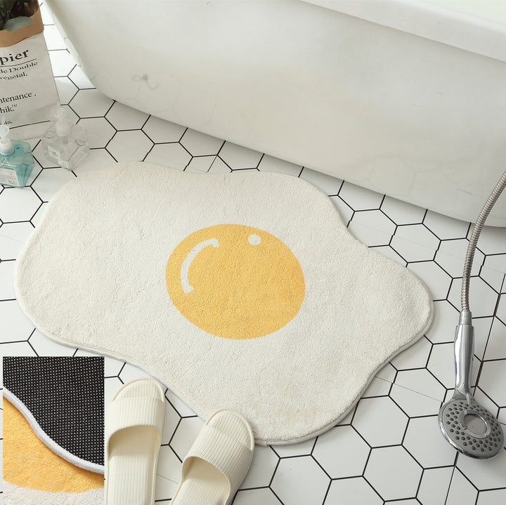 VibeCore Sunny-Side Up Egg Accent Rug used as a bathmat, featuring its playful fried egg design, soft plush texture, non-slip backing, and cute rug appeal. A fun and quirky addition to any bathroom or modern bedroom, dorm, or living room decor.