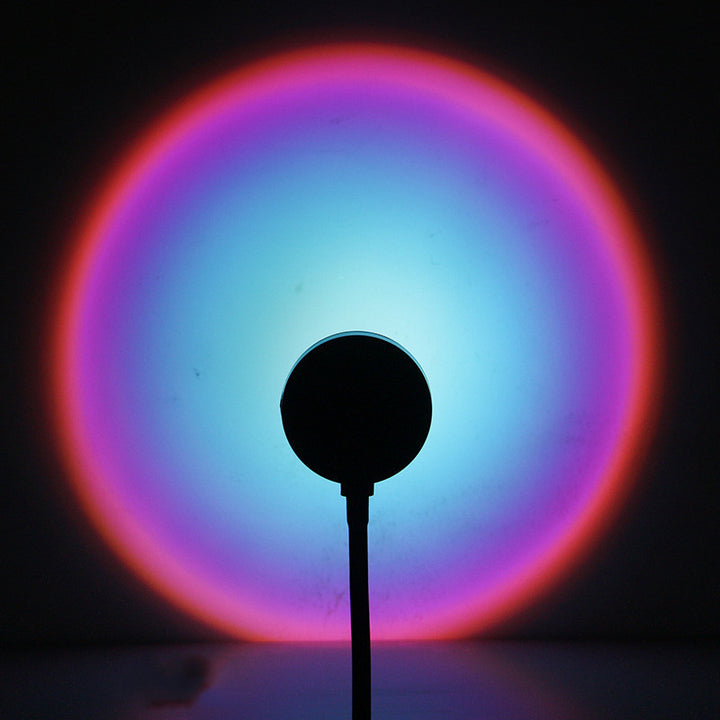 VibeCore Sunset Lamp with a blue interior and pink exterior, casting a soft, dreamy glow on the wall, creating a tranquil and aesthetic ambiance.