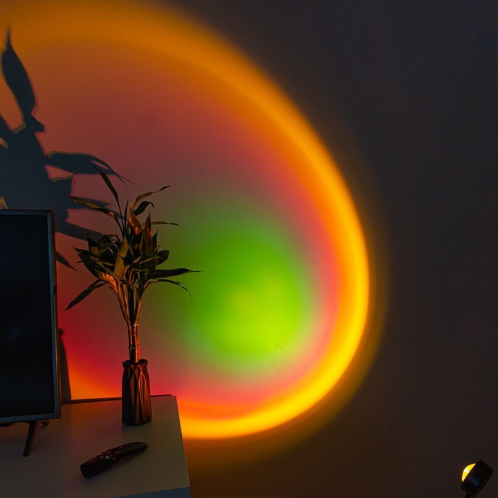 VibeCore Sunset Lamp projecting a green center with an orange exterior on a living room wall, adding a vibrant and aesthetic glow.