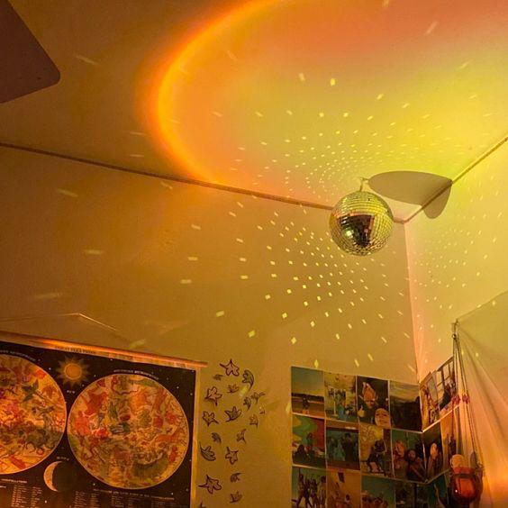 VibeCore Sunset Lamp casting an orange glow reflecting off a disco ball, creating a vibrant, aesthetic light effect for trendy room decor.