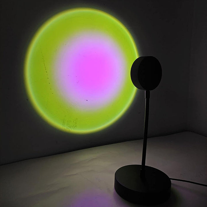 VibeCore Sunset Lamp with a pink interior and green exterior, projecting soft pastel lighting on the wall, creating a tranquil and aesthetic ambiance.