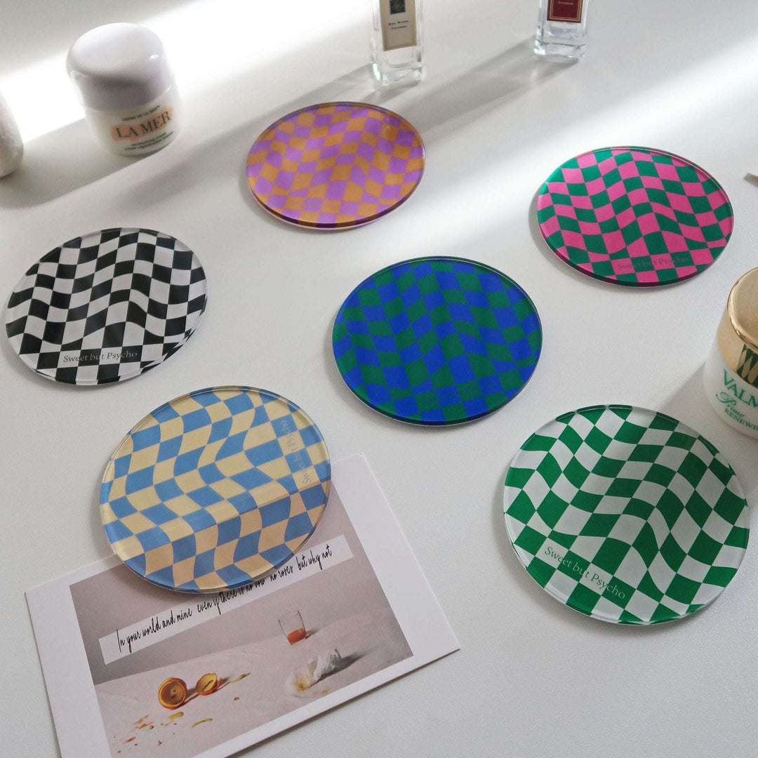 The VibeCore Sweet But Psycho Checkerboard Coaster is available in six vibrant colors: Black, Green, Blue, Gray, Pink, and Orange. With a cheeky design featuring the phrase “Sweet But Psycho” set against a bold checkerboard pattern, these coasters are crafted from high-quality acrylic, offering both durability and style. Perfect for adding personality and protecting your surfaces in a fun, playful way.