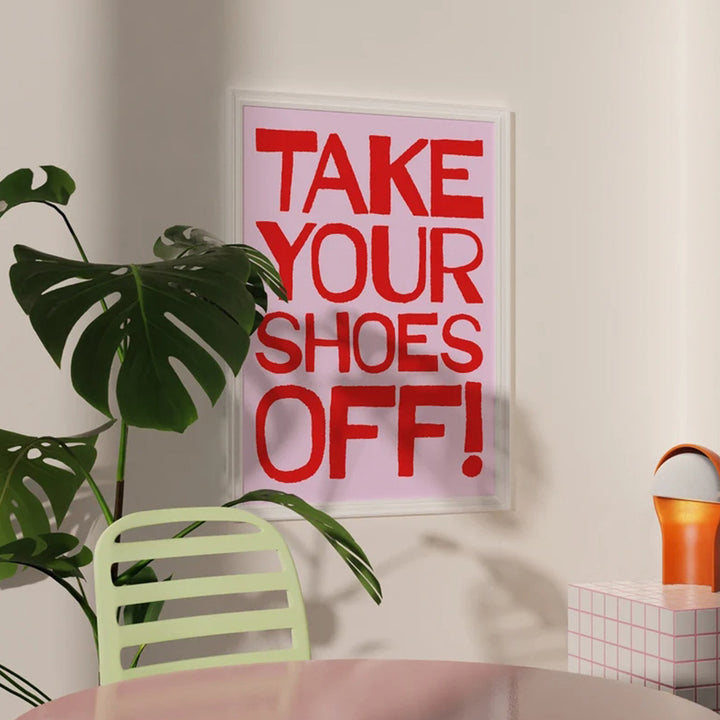 VibeCore Take Your Shoes Off Canvas Poster featuring vibrant, playful typography in bold colors. The retro-inspired design with a quirky message adds a fun and eclectic touch to any room, perfect for entryways, dorms, or apartments. The poster is framed on the wall, showcasing its unique and contemporary vibe.