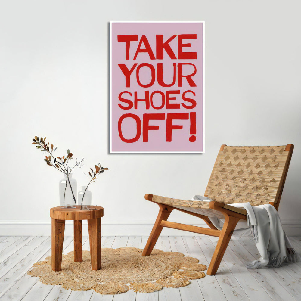 VibeCore Take Your Shoes Off Canvas Poster displayed on the wall. The bold typography in vibrant colors brings a quirky, playful touch to any space, ideal for entryways, dorms, or apartments, adding a fun and eclectic vibe to the decor.