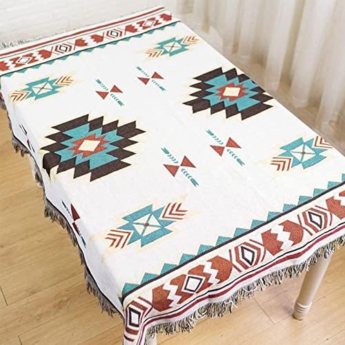 : VibeCore Terra Medallion Woven Blanket draped on a table, showcasing its earthy medallion pattern and soft, textured fabric, adding a bohemian, artistic touch to the room.