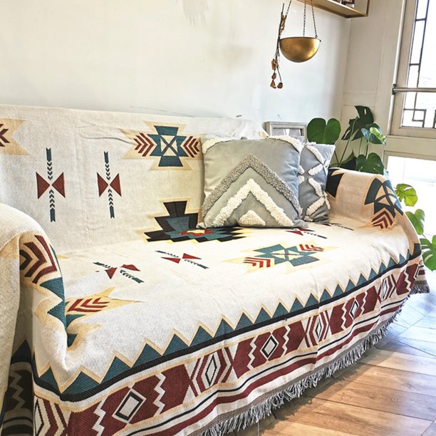 VibeCore Terra Medallion Woven Blanket on a couch in a living room, featuring its earthy medallion design, adding a cozy, bohemian vibe to the space with its soft, textured cotton fabric.
