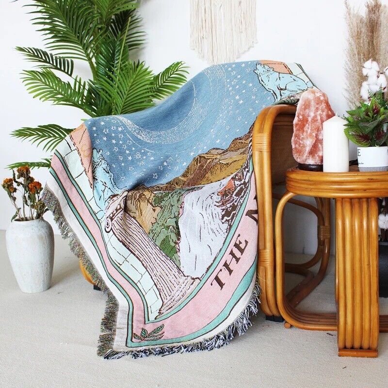 VibeCore The Moon Tarot Woven Blanket on chair, featuring celestial-inspired design and soft 100% combed cotton texture.
