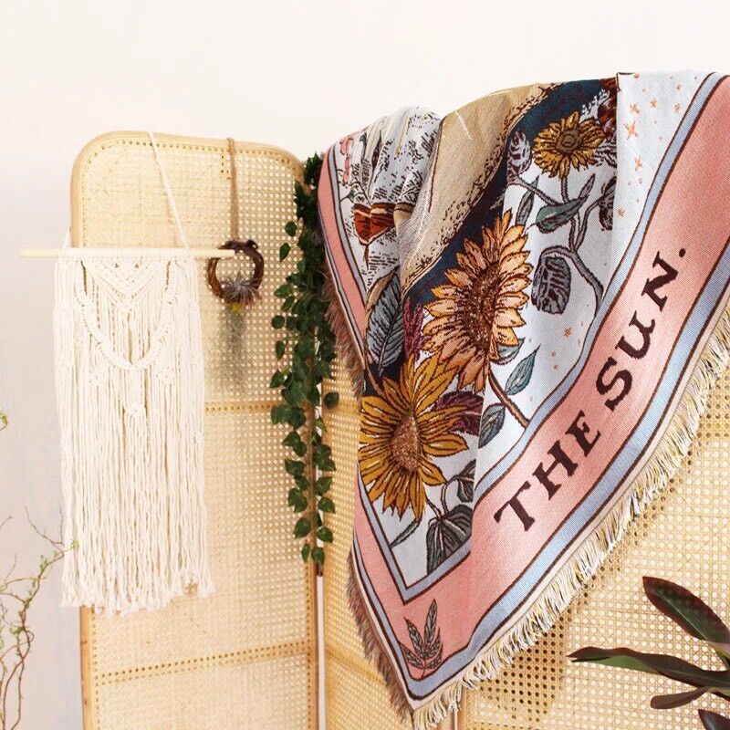 VibeCore The Sun Tarot Woven Blanket on room divider, showcasing its celestial-inspired design with vibrant, reversible patterns. Crafted from soft, breathable 100% combed cotton, it adds a cosmic, artistic touch while dividing your space with style and versatility.
