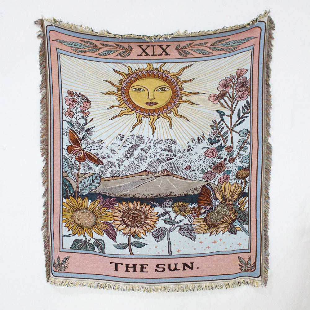 VibeCore The Sun Tarot Woven Blanket product view, showcasing its celestial-inspired design with vibrant, reversible patterns. Crafted from 100% combed cotton, it combines comfort and style, offering versatility as a throw, wall tapestry, rug, or tablecloth to elevate any room.