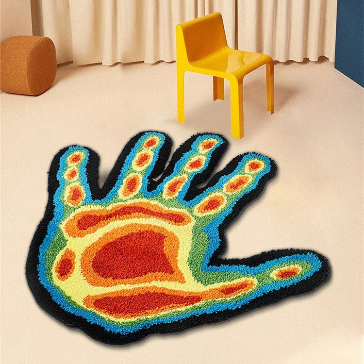 Angled aerial view of the "Thermal Hand Accent Rug," showcasing its bold thermal-inspired hand graphic and vibrant color gradient. The plush texture and non-slip backing are visible, making it a stylish and functional addition to any space.