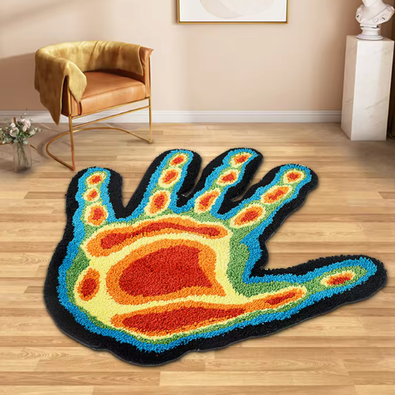 Thermal Hand Accent Rug" on a wooden floor, showcasing its bold thermal-inspired hand design and vibrant color gradient. The contrast between the rug's plush texture and the smooth wood enhances its artistic appeal.