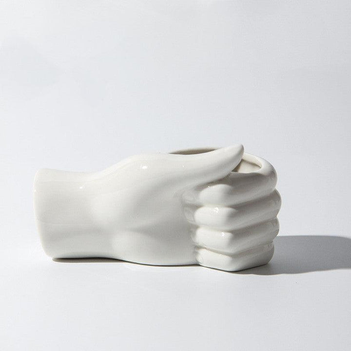 Modern ceramic vase in a hand thumbs-up shape, perfect for adding quirky charm and bold style to any space.