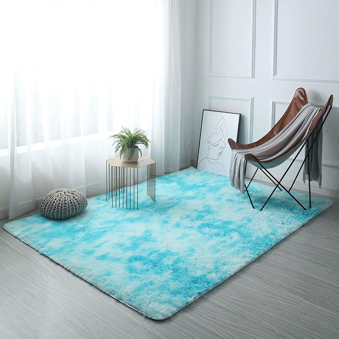 VibeCore Tie-Dye Area Rug Aqua on floor, vibrant aqua tie-dye design, soft polyester fiber construction with non-slip backing, ideal for creating a bold, retro aesthetic in any room.