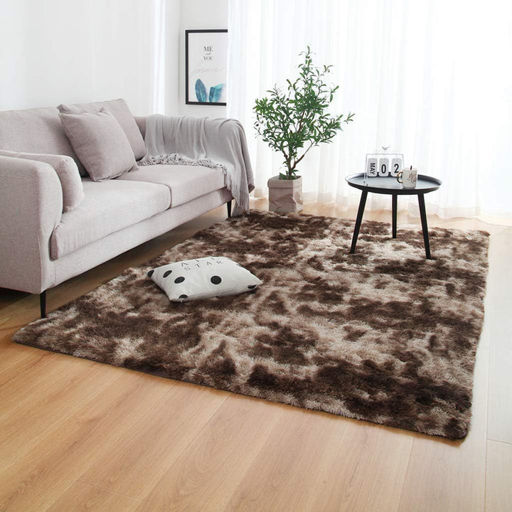 VibeCore Tie-Dye Area Rug Brown on living room floor, soft polyester fiber rug with vibrant brown tie-dye pattern, non-slip backing for safety, perfect for modern living room decor.
