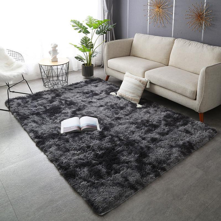 VibeCore Tie-Dye Area Rug Dark Gray on living room floor, soft polyester fiber rug with vibrant dark gray tie-dye pattern, non-slip backing for safety, perfect for modern living room decor.
