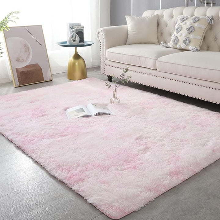 VibeCore Tie-Dye Area Rug Light Pink on living room floor, soft polyester fiber rug with vibrant light pink tie-dye pattern, non-slip backing for safety, perfect for modern living room decor.